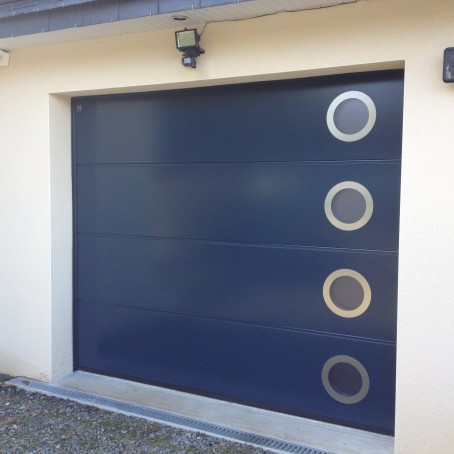 Porte de garage sectionnelle avec hublots de forme rondes
